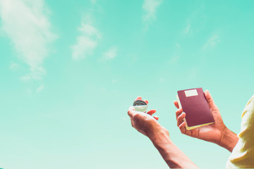 Man asian holding passport and compass on sky background