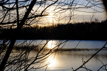 Fototapeta premium Beautiful lake and forest landscape during a colorful and dramatic sunset