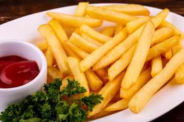 French fries fried in oil with ketchup