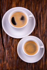 Coffee with milk on saucers