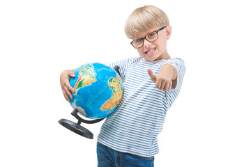 Fototapeta premium Cute little child isolated on white background holding globe. Schoolboy study geography. Cute boy travel. Family vacation with children
