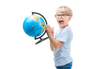 Fototapeta premium Cute little child isolated on white background holding globe. Schoolboy study geography. Cute boy travel. Family vacation with children