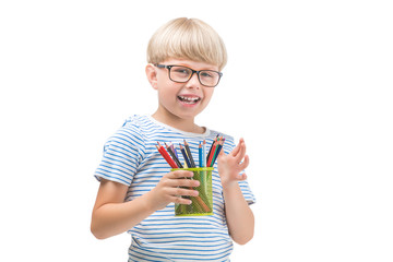 Isolated child with pencils. Adorable kid on white background. Portrait of funny blonde boy with colorful pencils.