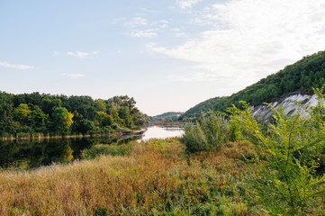 Safety life. Sunny day a calm river in summer. Beauty wild nature landscape. Ecology concept. Environmental protection. Water without pollution. Reserve of nature. Wild planet