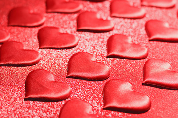 Many red hearts on a red background. Romantic love, Valentine's Day, birthday, wedding, holiday. Selective focus.