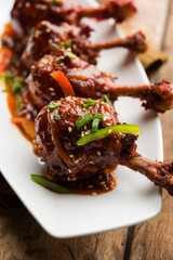 Szechuan Chicken which is a popular Indo-Chinese non vegetarian recipe. served in a plate with chilli sauce. selective focus