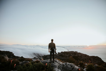 Rear view of man standing on rock