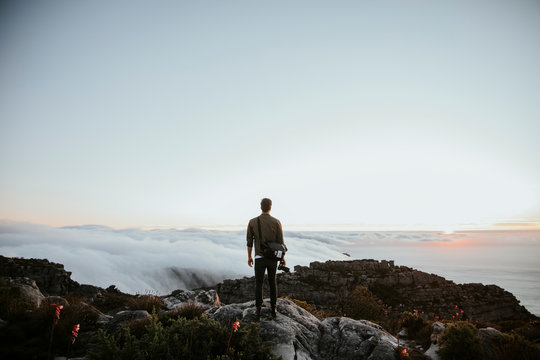 Rear view of man standing on rock