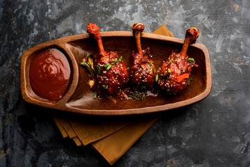 Szechuan Chicken which is a popular Indo-Chinese non vegetarian recipe. served in a plate with...