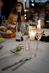 Dinner table at a wedding with candles and wine glasses
