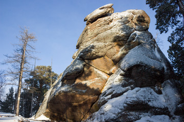 Winter view on rock pillar or Stolb a Lion Gate in Russian strict ecological reserve Stolby Nature Sanctuary near city of Krasnoyarsk. The site is known for its dramatic complexes of rocks