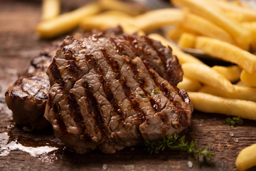 Grilled beef steak on wooden cutting board