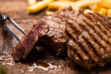 Grilled beef steak on wooden cutting board