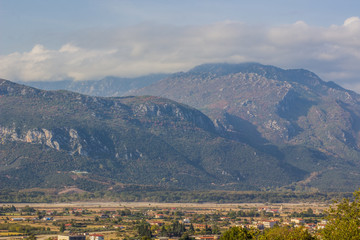 Fototapeta na wymiar outskirts suburb village valley foreground and foggy mountain ridge background landscape 