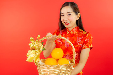 chinese new year beautiful happy smiley asia chiness girl ware Qipao Oriental Chic Cheongsam with red background copy space isolated