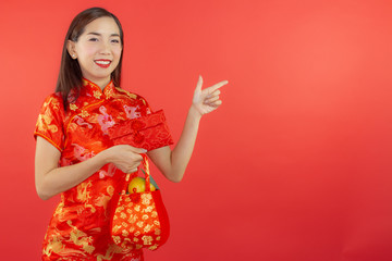 chinese new year beautiful happy smiley asia chiness girl ware Qipao Oriental Chic Cheongsam with red background copy space isolated