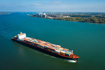 Aerial view of a container ship going upstream in the St. Lawrence River near the port of Montreal...