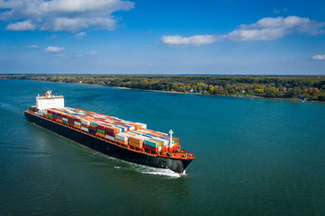 Aerial view of a container ship going upstream in the St. Lawrence River near the port of Montreal...