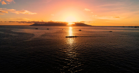 canoe and boat with Sunset in french polynesia