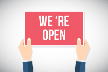 Hands holding placard with " WE 'RE OPEN " sign. Flat style vector illustration.