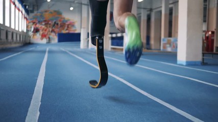 A runner training with prosthetic leg, back view. - Powered by Adobe
