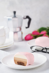 Pink heart shaped mousse cakes with chocolate filling.