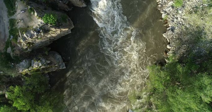Superwide aerial view of flooded white water river