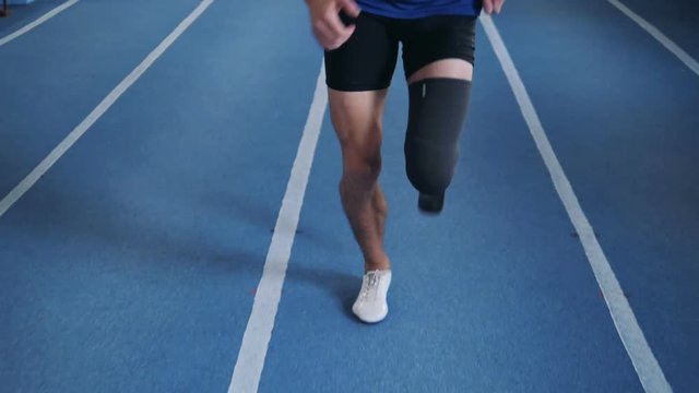 Professional runner with leg prosthesis, close up.
