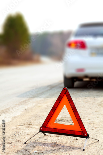 White Car And A Red Triangle Warning Sign On The Road Stock Photo White Car And A Red Triangle Warning Sign On The Road