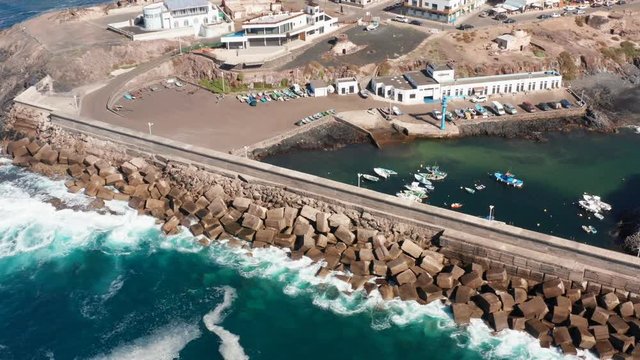 Aerial view of El Cotillo harbour wall and marina