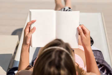 Girl lying reading a book