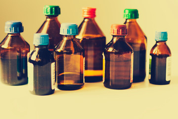 Medicine bottles on white background with copy scape for text, retro concept closeup.