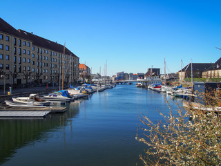 Fototapeta na wymiar View of the contemporary architecture and water canals of the Christianshavn district in Copenhagen, Denmark