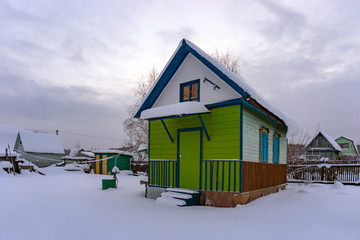 Multi-colored country house in winter