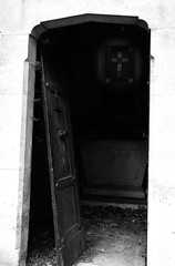 door of an old grave in the abandoned cemetery with black and wh