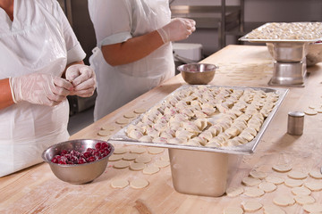 human hands mold cherry dumplings handwork
