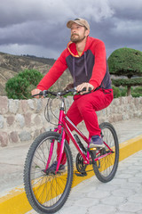 Fototapeta premium A man on a bicycle in the open air, rides along the road. Sports events, sports riding.
