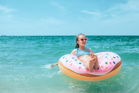 Teenage girl relaxing on inflantable ring