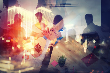 Handshaking business person in office. concept of teamwork and partnership. double exposure with light effects