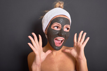 Emotional woman with black mask on her face