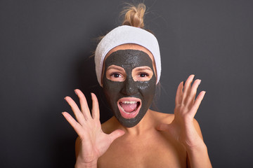 Emotional woman screaming with black mask on her face