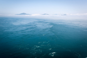 View of the ocean in Japan with horizon and cloudy sky