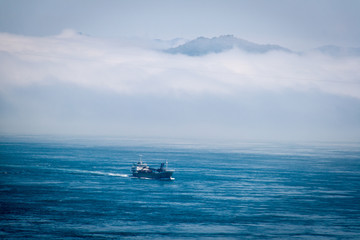 Boat in the sea with cloudy sky