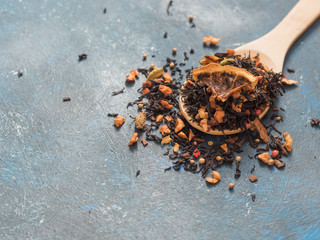 Dry leaves of black fruit tea with cinnamon, apple, orange, coriander, cardamom, cloves and red pepper