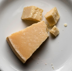 parmigiano reggiano, famous italian cheese, on white plate
