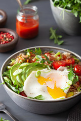 quinoa bowl with fried egg, avocado, tomato, rocket. Healthy vegetarian lunch