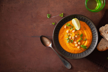 creamy carrot chickpea soup on dark rustic background
