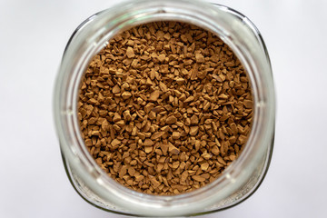 Obraz na płótnie Canvas Instant coffee granules in a round jar
