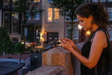 Young woman photographer with camera on a bridge