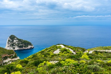 Greece, Zakynthos, Twisting mountain road down to the coast through green paradise